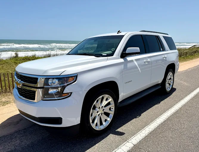 White Chevy Tahoe at Florida beachside — mobile tinting at its finest